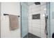 Glass shower features a rainfall shower head, mosaic tiling, and a built-in shelf at 9120 N 86Th Way, Scottsdale, AZ 85258