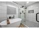 This walk-in shower features black fixtures, tiled walls and a rainfall shower head at 9120 N 86Th Way, Scottsdale, AZ 85258