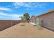 View of the spacious backyard with desert landscaping and a secure block fence for added privacy at 9349 E Navajo Pl, Sun Lakes, AZ 85248