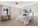Cozy bedroom with soft pink curtains and a comfortable-looking bed at 9349 E Navajo Pl, Sun Lakes, AZ 85248