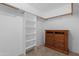 Walk-in closet with built-in shelving and a wooden dresser on carpeted floor at 9349 E Navajo Pl, Sun Lakes, AZ 85248