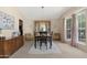 Classic dining room with carpet, china cabinet, and natural light at 9349 E Navajo Pl, Sun Lakes, AZ 85248