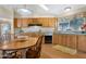 Charming kitchen with wood cabinets, a bright window over the sink, plenty of counter space and a breakfast nook at 9349 E Navajo Pl, Sun Lakes, AZ 85248