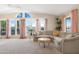 Cozy living room with vaulted ceilings, large windows, and stylish couch at 9349 E Navajo Pl, Sun Lakes, AZ 85248
