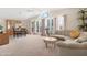 Bright living room with vaulted ceilings, large windows, and neutral carpet at 9349 E Navajo Pl, Sun Lakes, AZ 85248