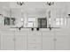 Bright bathroom featuring a double vanity with modern fixtures and a large mirror at 948 E La Mirada Dr, Phoenix, AZ 85042