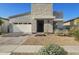 Modern home featuring a light stone facade, an attached garage, and xeriscaped front yard at 948 E La Mirada Dr, Phoenix, AZ 85042