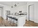 Sleek kitchen features a large island, stainless steel appliances, white cabinetry, and modern pendant lighting at 948 E La Mirada Dr, Phoenix, AZ 85042