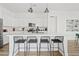 Open-concept kitchen features white cabinetry, a large island, and a seamless transition to dining and living at 948 E La Mirada Dr, Phoenix, AZ 85042