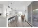 Bright open-concept kitchen, dining and living area with hardwood floors and modern light fixtures at 948 E La Mirada Dr, Phoenix, AZ 85042