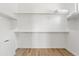 Spacious walk-in closet with ample shelving and wood-look flooring at 948 E La Mirada Dr, Phoenix, AZ 85042