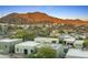 Desert homes nestled in a desert landscape with views of the surrounding mountains and blue sky at 10005 N 1St Dr, Phoenix, AZ 85021