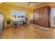 Inviting bedroom with a Murphy bed, desk, hardwood floors, and outdoor access, perfect for relaxing or working at 10005 N 1St Dr, Phoenix, AZ 85021