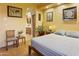Inviting bedroom with hardwood floors, neutral tones, side table, and an arched doorway to a bathroom at 10005 N 1St Dr, Phoenix, AZ 85021
