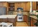Updated kitchen boasts stainless steel appliances, custom cabinets, granite countertops, and a center island at 10005 N 1St Dr, Phoenix, AZ 85021