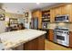 The gourmet kitchen boasts stainless appliances, granite countertops, and a center island with seating at 10005 N 1St Dr, Phoenix, AZ 85021