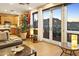 Well-lit living room with a kitchen area, large windows, and access to a patio with mountain views at 10005 N 1St Dr, Phoenix, AZ 85021