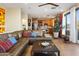 The comfortable living room boasts a leather sectional, hardwood floors, and an open layout to the kitchen at 10005 N 1St Dr, Phoenix, AZ 85021
