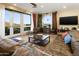 Cozy living room with a leather sofa, expansive windows, and access to outdoor balcony at 10005 N 1St Dr, Phoenix, AZ 85021