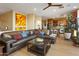 Spacious living room with a leather sectional, hardwood floors, and open layout to the kitchen at 10005 N 1St Dr, Phoenix, AZ 85021