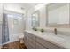 Bright bathroom with double vanity, granite countertops, and a shower-tub combo with tile surround at 10417 W Alyssa Ln, Peoria, AZ 85383