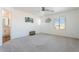 Bright bedroom featuring neutral carpet, white walls, ceiling fan, and natural light from several windows at 10417 W Alyssa Ln, Peoria, AZ 85383