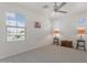 Light bedroom with neutral carpet, a ceiling fan, and large windows providing ample natural light at 10417 W Alyssa Ln, Peoria, AZ 85383