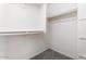 Spacious walk-in closet with neutral carpet and white shelving at 10417 W Alyssa Ln, Peoria, AZ 85383