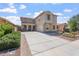 Stunning two-story home featuring a long driveway, desert landscaping, and charming arched front porch at 10417 W Alyssa Ln, Peoria, AZ 85383