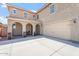 Charming home showcasing a covered front porch with arched entryways and an attached two-car garage at 10417 W Alyssa Ln, Peoria, AZ 85383