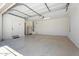 Bright garage with epoxy flooring and a refrigerator at 10417 W Alyssa Ln, Peoria, AZ 85383