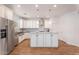 Spacious kitchen boasts white cabinets, a large island, and modern stainless appliances at 10417 W Alyssa Ln, Peoria, AZ 85383