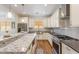 Modern kitchen features granite countertops, stainless steel appliances, and a center island at 10417 W Alyssa Ln, Peoria, AZ 85383