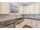 Well-lit kitchen has stainless steel sink, stylish cabinets and a large window at 10417 W Alyssa Ln, Peoria, AZ 85383