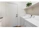 Bright laundry room with modern appliances and a convenient overhead shelf for storage at 10417 W Alyssa Ln, Peoria, AZ 85383