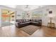 Comfortable living room featuring a large couch, outdoor access, and plenty of light at 10417 W Alyssa Ln, Peoria, AZ 85383