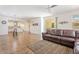 Open-concept living area with wood floors, patio access, and a comfortable sectional sofa at 10417 W Alyssa Ln, Peoria, AZ 85383