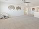 Open loft area with neutral carpet, modern wall decor, and a cozy seating option at 10417 W Alyssa Ln, Peoria, AZ 85383