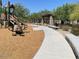 Community playground with swings, slides, and a walking path in a well-maintained neighborhood at 10417 W Alyssa Ln, Peoria, AZ 85383