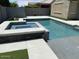 Modern backyard pool and spa with sleek tile, concrete decking, and a private fenced yard at 10417 W Alyssa Ln, Peoria, AZ 85383