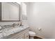 Stylish powder room featuring granite counters, modern fixtures, and wood-look tile floors at 10417 W Alyssa Ln, Peoria, AZ 85383