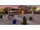 Features a covered patio, a horseshoe pit and lush greenery, perfect for outdoor activities at 10561 E Plata Ave, Mesa, AZ 85212