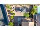 Aerial view highlighting the meticulously landscaped backyard featuring a gazebo, firepit, and green spaces at 10561 E Plata Ave, Mesa, AZ 85212
