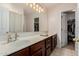 This dual sink bathroom features a large mirror with modern lighting, perfect for a couple at 10561 E Plata Ave, Mesa, AZ 85212