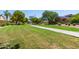 Lush community park area with walking path, grassy field, and mature shade trees at 10561 E Plata Ave, Mesa, AZ 85212