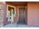 Inviting front entrance showcasing a secure brown door, complemented by a decorative metal cactus sculpture at 10561 E Plata Ave, Mesa, AZ 85212
