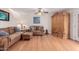 Inviting living room showcasing hardwood floors, a ceiling fan, plush sofas, and elegant decor at 10561 E Plata Ave, Mesa, AZ 85212