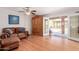 Inviting living room features gleaming hardwood floors, french doors to backyard, and leather sofa at 10561 E Plata Ave, Mesa, AZ 85212