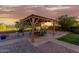 Features a covered patio with string lights, creating a cozy outdoor space for dining and relaxation at 10561 E Plata Ave, Mesa, AZ 85212