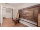 Elegant sitting room with hardwood floors and a decorative accent chair set near an ornate bed frame at 10561 E Plata Ave, Mesa, AZ 85212